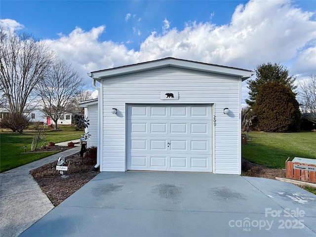 garage featuring a lawn