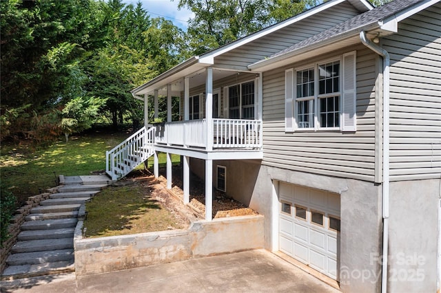 exterior space with covered porch and a garage