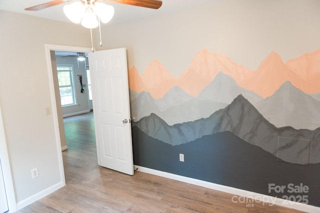 spare room featuring ceiling fan and wood-type flooring