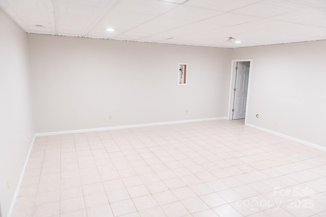 tiled spare room with a drop ceiling