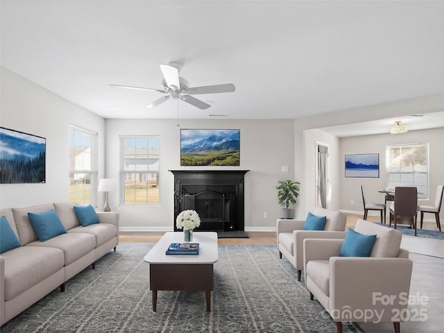 living room with ceiling fan and wood-type flooring