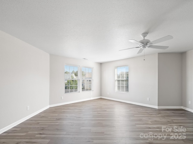 unfurnished room with dark wood-type flooring and baseboards