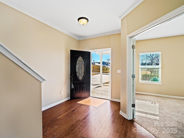 foyer with ornamental molding and dark hardwood / wood-style flooring