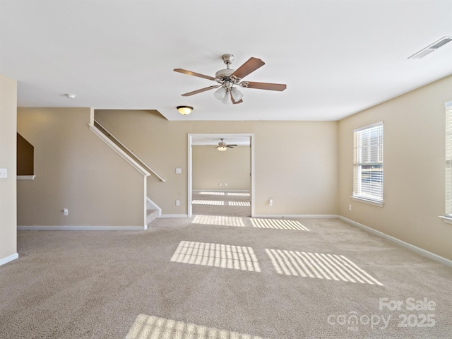 carpeted empty room featuring ceiling fan