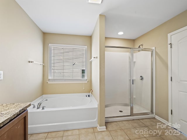 bathroom with tile patterned floors, separate shower and tub, and vanity