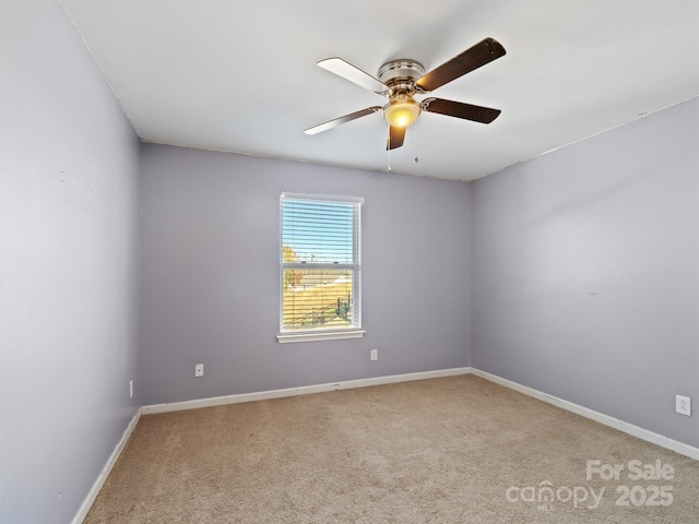 spare room featuring ceiling fan and light colored carpet