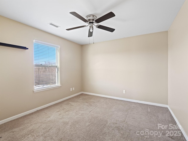 unfurnished room featuring light carpet and ceiling fan