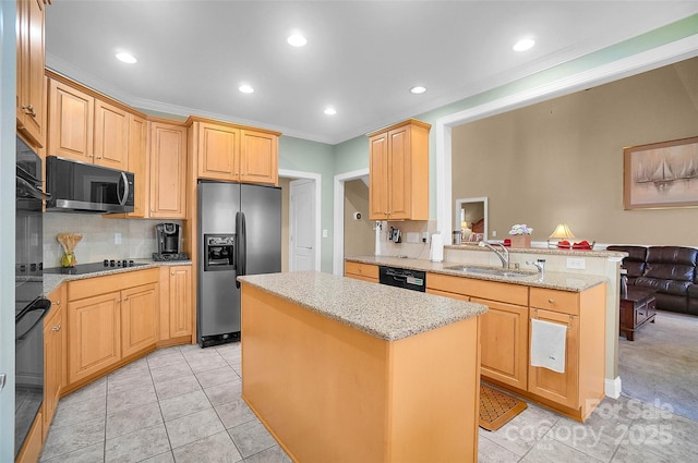 kitchen with a peninsula, a sink, ornamental molding, a center island, and black appliances