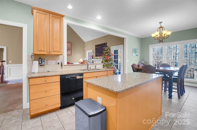 kitchen featuring dishwasher, wainscoting, a notable chandelier, light brown cabinetry, and a sink