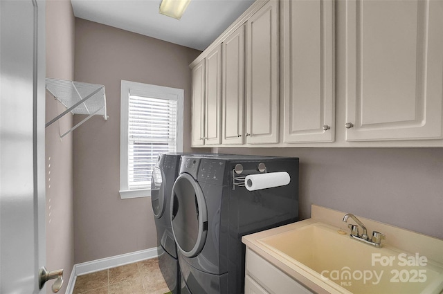 clothes washing area featuring independent washer and dryer, a sink, cabinet space, and baseboards