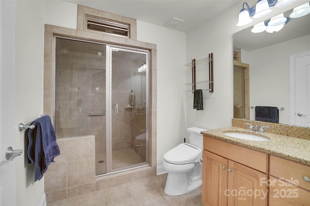 bathroom with visible vents, toilet, vanity, a shower stall, and tile patterned floors