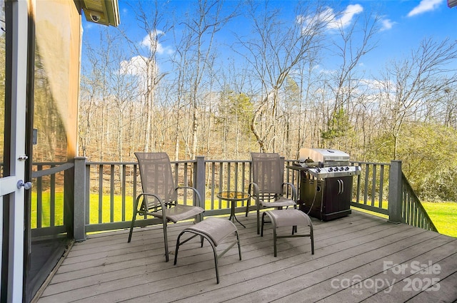 wooden deck featuring area for grilling