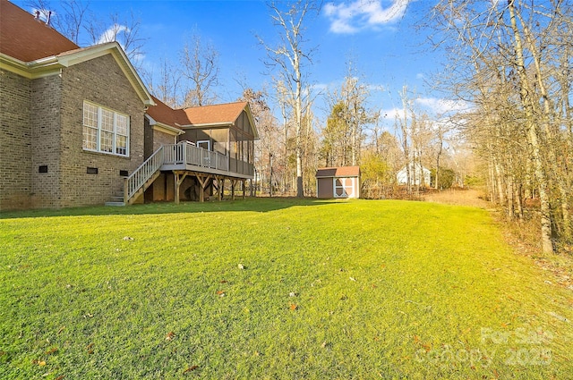 view of yard featuring an outbuilding, stairway, a wooden deck, and a shed