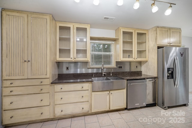 kitchen featuring light tile patterned floors, stainless steel appliances, and sink