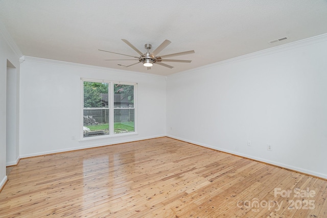 spare room featuring light hardwood / wood-style flooring, ceiling fan, and ornamental molding