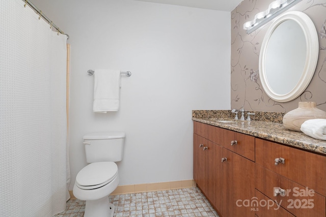 bathroom with tile patterned floors, vanity, and toilet