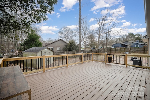 wooden terrace featuring a storage unit