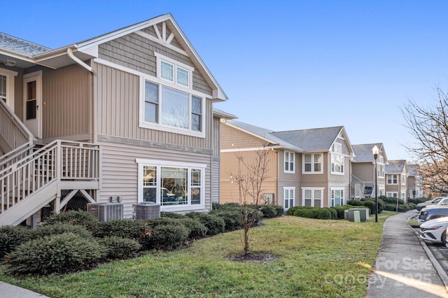 view of property exterior featuring a lawn and central AC