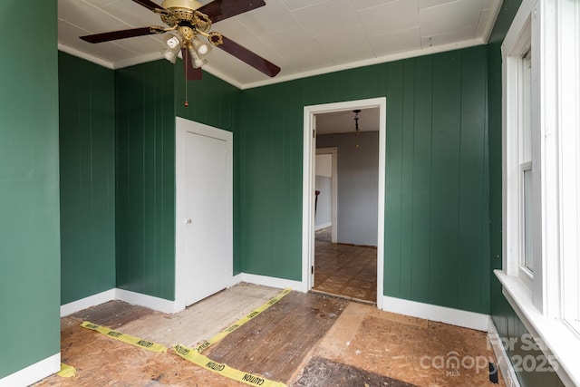 unfurnished bedroom with ceiling fan and ornamental molding