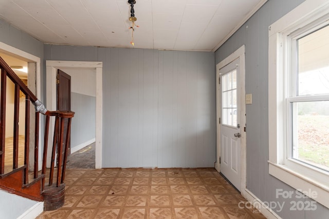 foyer featuring light parquet floors and wood walls