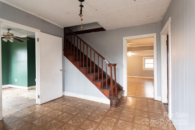 stairs featuring parquet floors and ceiling fan