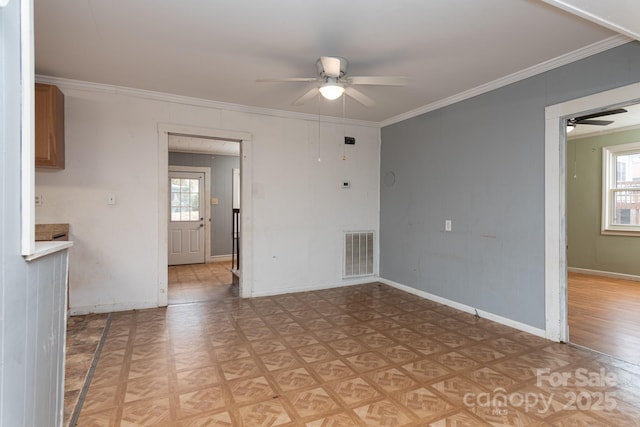 spare room featuring light parquet floors, ceiling fan, and ornamental molding