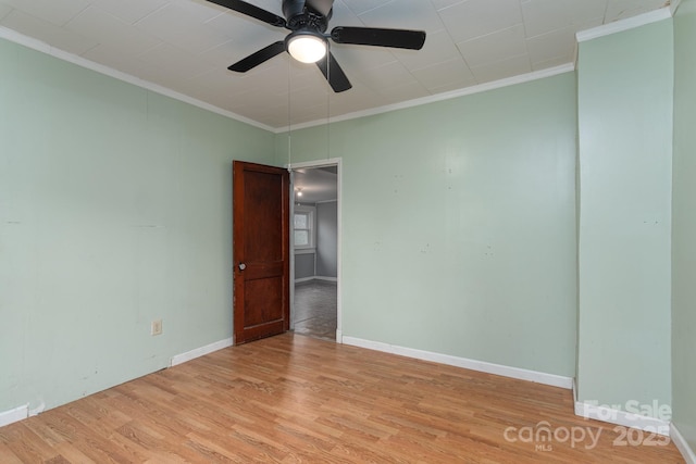 spare room featuring crown molding, ceiling fan, and light hardwood / wood-style floors