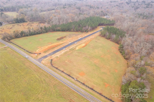 birds eye view of property with a rural view