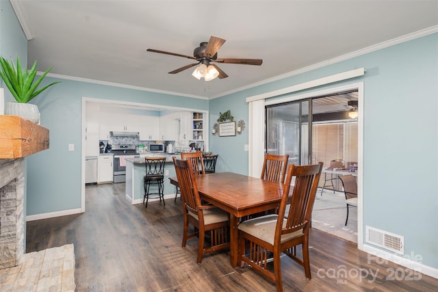 dining space with a fireplace, ceiling fan, dark hardwood / wood-style flooring, and ornamental molding