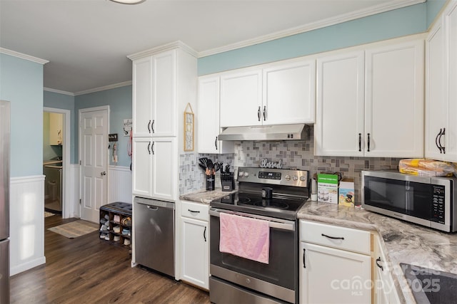 kitchen featuring stainless steel appliances, white cabinetry, ornamental molding, and light stone counters