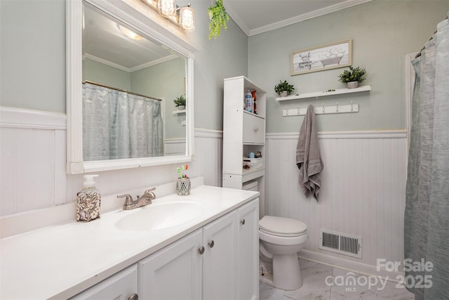 bathroom featuring vanity, toilet, and crown molding