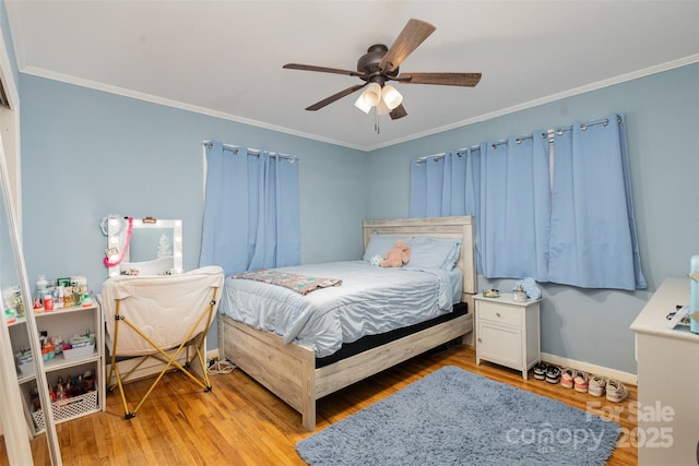 bedroom with ceiling fan, ornamental molding, and light wood-type flooring