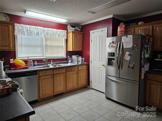 kitchen with crown molding, sink, light tile patterned floors, a textured ceiling, and stainless steel appliances