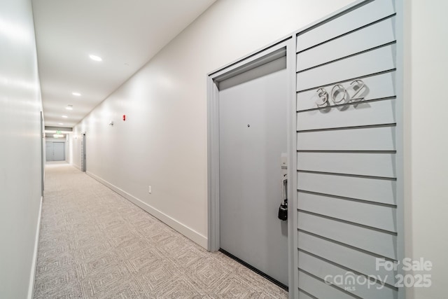 hall featuring light colored carpet