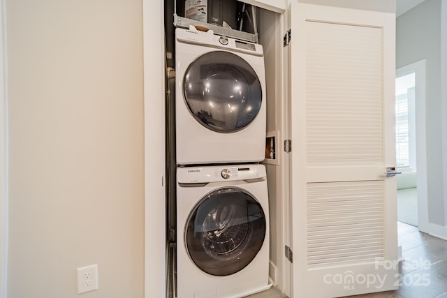 laundry room with stacked washing maching and dryer