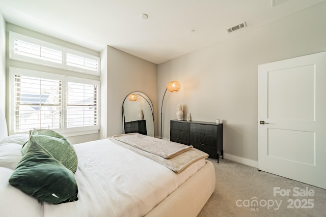 bedroom featuring light colored carpet