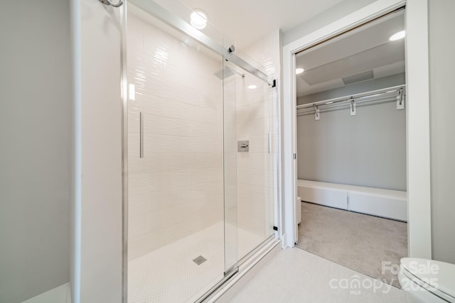 bathroom featuring a shower with shower door