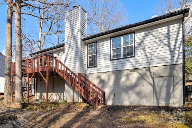 back of house with a wooden deck