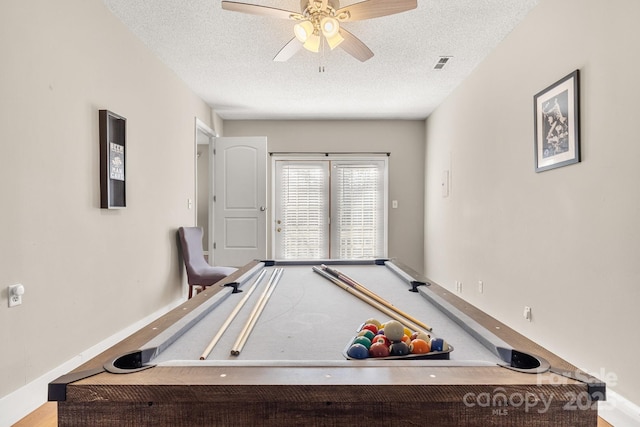 rec room with a textured ceiling, ceiling fan, and pool table