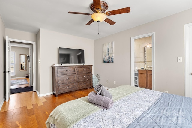 bedroom with ceiling fan, ensuite bathroom, and light hardwood / wood-style flooring