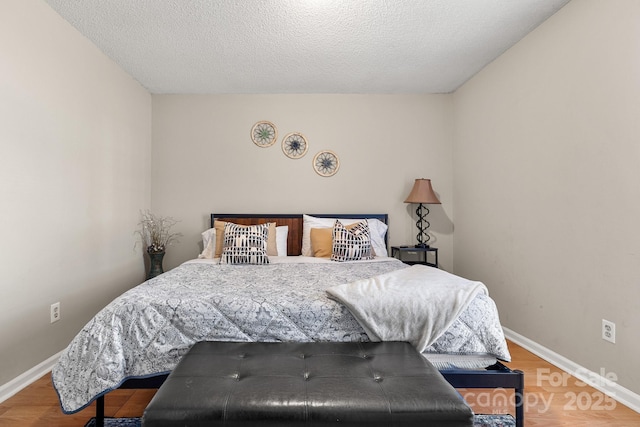 bedroom featuring wood-type flooring and a textured ceiling