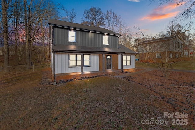 view of back house at dusk