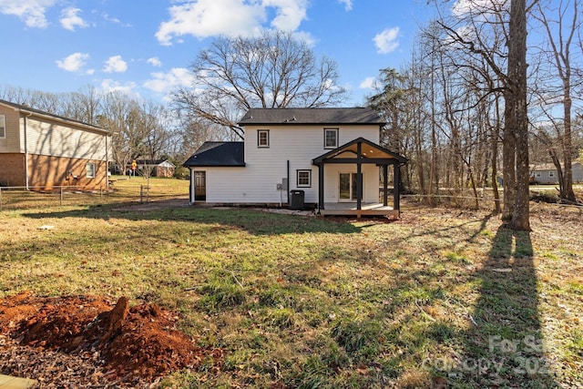 back of house with a lawn