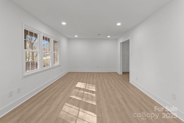 spare room with light hardwood / wood-style flooring