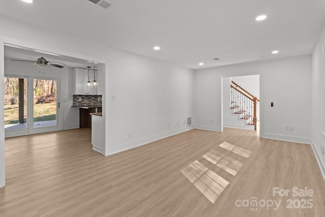 unfurnished living room featuring light hardwood / wood-style floors and ceiling fan