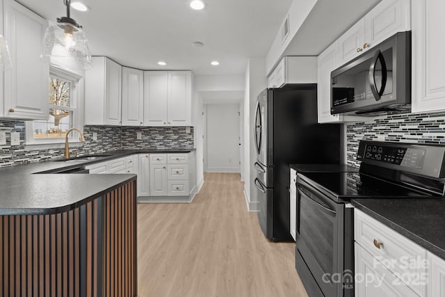 kitchen featuring decorative light fixtures, white cabinetry, stainless steel electric range oven, and sink