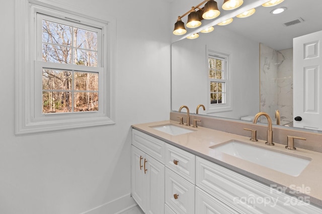 bathroom with plenty of natural light and vanity