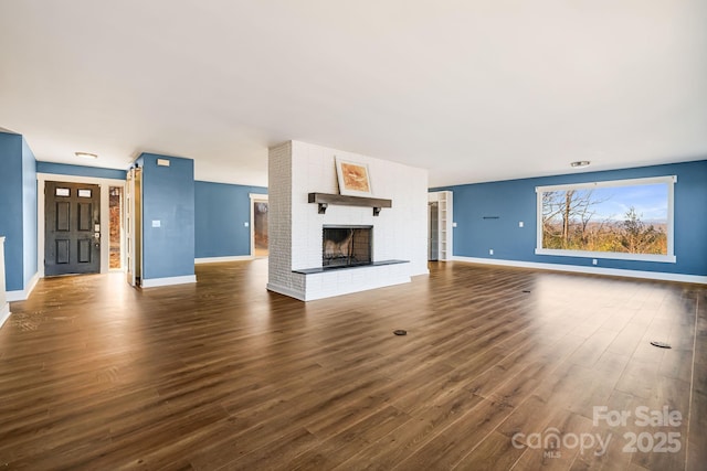 unfurnished living room featuring dark hardwood / wood-style floors and a fireplace