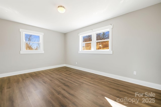 spare room featuring dark hardwood / wood-style flooring