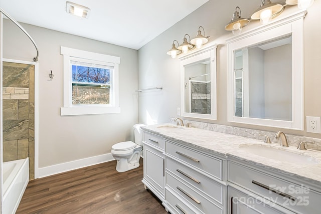 full bathroom featuring wood-type flooring, vanity, toilet, and tub / shower combination